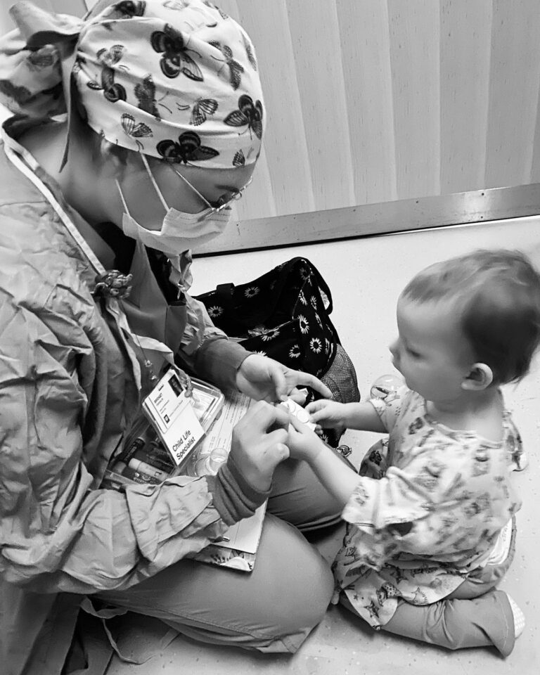 a baby with a nurse in an indoor setting