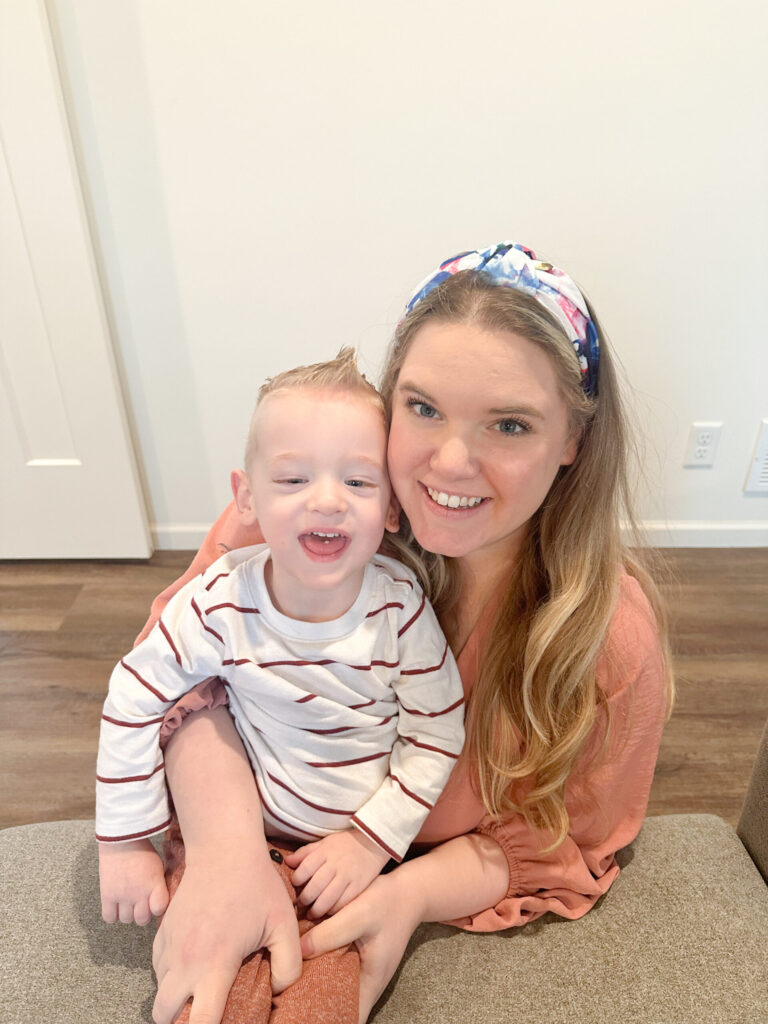 portrait of a happy mom and son taken in a bright indoor setting.